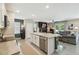 Open-concept kitchen with granite countertops, stainless steel appliances, and view to the living room at 7591 Cypress Walk Dr, New Port Richey, FL 34655