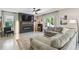 Cozy living room with an electric fireplace, large windows, and comfortable seating for relaxation and entertainment at 7591 Cypress Walk Dr, New Port Richey, FL 34655