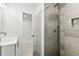 Well-lit bathroom featuring a modern shower with gray tiling and sleek fixtures at 8721 N Whittier St, Tampa, FL 33617