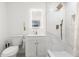 Modern bathroom featuring white marble shower, matching vanity, gold accents, and bright lighting at 8721 N Whittier St, Tampa, FL 33617