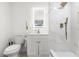 Modern bathroom featuring white marble shower, matching vanity, gold accents, and bright lighting at 8721 N Whittier St, Tampa, FL 33617