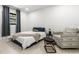 Well-lit bedroom featuring a bed, decorative rug and comfortable seating area at 8721 N Whittier St, Tampa, FL 33617