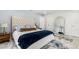 Comfortable bedroom features a bed, decorative mirror, and a soothing blue accent wall at 8721 N Whittier St, Tampa, FL 33617