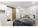 Bright bedroom with modern decor, a sliding barn door to bathroom, and geometric wall design at 8721 N Whittier St, Tampa, FL 33617