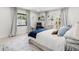 Bright bedroom with a window, french doors, a rug, and modern decor at 8721 N Whittier St, Tampa, FL 33617