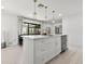Stylish kitchen with a quartz island, pendant lighting, and an adjacent dining area at 8721 N Whittier St, Tampa, FL 33617