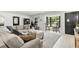 Bright, modern living room with large windows and comfortable seating area at 8721 N Whittier St, Tampa, FL 33617
