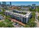 An aerial view of the residential building surrounded by greenery and city skyline at 105 4Th Ne Ave # 220, St Petersburg, FL 33701
