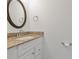 Bathroom featuring granite countertop vanity, a decorative mirror, and modern fixtures at 105 4Th Ne Ave # 220, St Petersburg, FL 33701