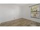 Empty bedroom with white walls, wood look floors and window with blinds at 105 4Th Ne Ave # 220, St Petersburg, FL 33701