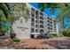 A multi-story residential building with balconies, covered parking and landscaping at 105 4Th Ne Ave # 220, St Petersburg, FL 33701