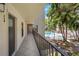Exterior hallway leading to unit with a view of the pool and tropical plants at 105 4Th Ne Ave # 220, St Petersburg, FL 33701