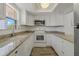 Updated kitchen with white cabinets, granite countertops, and stainless steel appliances at 105 4Th Ne Ave # 220, St Petersburg, FL 33701