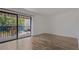 Bright living room featuring wood-look floors, neutral paint, and sliding glass doors to the balcony at 105 4Th Ne Ave # 220, St Petersburg, FL 33701