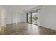 Bright living room featuring wood-look floors, closet, and sliding glass doors to the balcony at 105 4Th Ne Ave # 220, St Petersburg, FL 33701