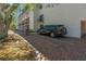Designated covered parking spaces with brick pavement at the building's ground floor at 105 4Th Ne Ave # 220, St Petersburg, FL 33701