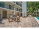 Ground floor outdoor seating area with tables and chairs near the building at 105 4Th Ne Ave # 220, St Petersburg, FL 33701