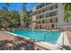 Inviting community pool area with lounge chairs, tables, and manicured landscaping at 105 4Th Ne Ave # 220, St Petersburg, FL 33701