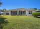 The home's backyard features a beautiful lush lawn and a screened-in lanai at 10534 Collar Dr, San Antonio, FL 33576