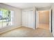 This carpeted bedroom includes a closet and an open doorway to another living space at 10534 Collar Dr, San Antonio, FL 33576