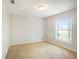 Bright bedroom with neutral walls, carpet, and a window that brings in natural light at 10534 Collar Dr, San Antonio, FL 33576