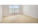 This carpeted bedroom offers natural light with an oversized window at 10534 Collar Dr, San Antonio, FL 33576