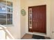 Inviting front entrance with a classic door, decorative window, and charming welcome sign at 10534 Collar Dr, San Antonio, FL 33576
