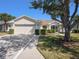Charming single-story home featuring a two-car garage, well-maintained landscaping, and a welcoming facade at 10534 Collar Dr, San Antonio, FL 33576