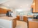 Spacious eat-in kitchen features stainless steel appliances, wooden cabinetry, and overlooks a dining area at 10534 Collar Dr, San Antonio, FL 33576