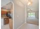 Open-concept living space featuring neutral tones, tile flooring, and view of the kitchen and living room at 10534 Collar Dr, San Antonio, FL 33576