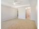 Large main bedroom with carpet flooring and a doorway leading to an attached bathroom with a garden tub at 10534 Collar Dr, San Antonio, FL 33576