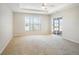 Spacious main bedroom features a ceiling fan, a bright window, and sliding door access to a screened patio at 10534 Collar Dr, San Antonio, FL 33576