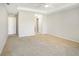 Spacious carpeted main bedroom featuring a doorway and closet and a large window with outside views at 10534 Collar Dr, San Antonio, FL 33576