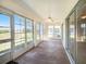 The sunroom features large windows, a fan, and plenty of natural light at 10534 Collar Dr, San Antonio, FL 33576