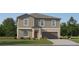 Charming two-story home with a two-car garage and inviting front yard at 12965 Shining Blue Nile Ln, Parrish, FL 34219