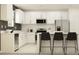 Modern kitchen with white cabinets, stainless steel appliances, and a breakfast bar with seating at 12965 Shining Blue Nile Ln, Parrish, FL 34219