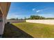 Fenced backyard with well-maintained lawn and plenty of open space at 1304 Tahitian Sunrise Dr, Plant City, FL 33565