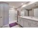 Bright bathroom featuring a double vanity, shower, and neutral-toned walls at 1304 Tahitian Sunrise Dr, Plant City, FL 33565