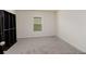 Bright bedroom with a window and built-in closet shelving for optimal storage and organization at 1304 Tahitian Sunrise Dr, Plant City, FL 33565