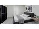 Modern bedroom featuring a large window, plush rug, and walk-in closet at 1304 Tahitian Sunrise Dr, Plant City, FL 33565
