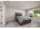 Neutral bedroom with carpet, window, bathroom access and a comfortable bed for restful sleep at 1304 Tahitian Sunrise Dr, Plant City, FL 33565