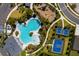 Aerial view of a resort-style community pool, sports courts, and a playground at 1304 Tahitian Sunrise Dr, Plant City, FL 33565