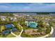Beautiful aerial view of a resort-style community pool, playground, and clubhouse at 1304 Tahitian Sunrise Dr, Plant City, FL 33565