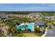 Aerial view showcasing the community pool, clubhouse, playground, and lush landscaping at 1304 Tahitian Sunrise Dr, Plant City, FL 33565