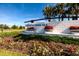 Beautiful community sign with colorful flowers and lush greenery at 1304 Tahitian Sunrise Dr, Plant City, FL 33565