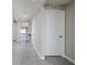 Bright hallway with gray tile flooring leading to living spaces at 1304 Tahitian Sunrise Dr, Plant City, FL 33565