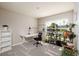 Well-lit office space with a modern desk and shelving for plants at 1304 Tahitian Sunrise Dr, Plant City, FL 33565