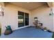Cozy covered patio with sliding glass doors and decorative plants and barrel table at 1304 Tahitian Sunrise Dr, Plant City, FL 33565