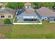 Aerial view of backyard, screened in patio, solar panels and white fenced-in yard with beautiful lawn at 13131 Early Run Ln, Riverview, FL 33578