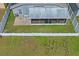 Birds eye view of backyard featuring a screened-in patio, white fence, and green lawn at 13131 Early Run Ln, Riverview, FL 33578